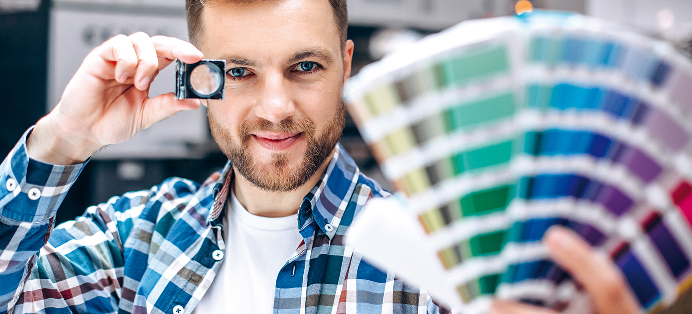 Man working in printing house with paper and paints Home